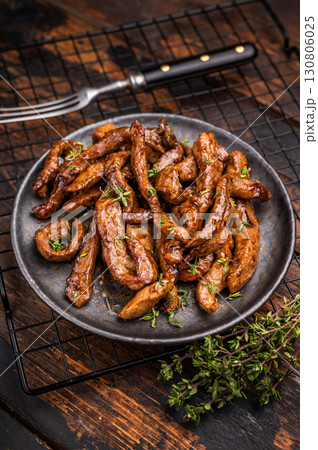 Traditional Asian beef teriyaki with herbs on a plate. wooden background. top view 130806025
