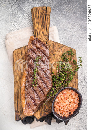 Grilled Top Sirloin, cooked rump beef steak. grey background. top view Grilled Top Sirloin, cooked rump beef steak. grey background. top view 130806028
