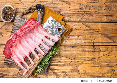 Butcher board with Raw lamb meat for chops steaks, fresh rack of mutton. wooden background. top view Butcher board with Raw lamb meat for chops steaks, fresh rack of mutton. wooden background. top view 130806061