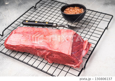 Close-up of raw buffalo meat cuts, highlighting the marbling and vibrant hue, perfect for creating delicious and nutritious dishes. grey background. top view 130806137