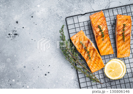 Grilled salmon fillet steak, roast fish on a rack. grey background. top view 130806146