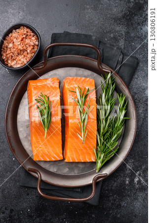 Raw Salmon fillet steak with rosemary ready for cooking. black background. top view 130806191