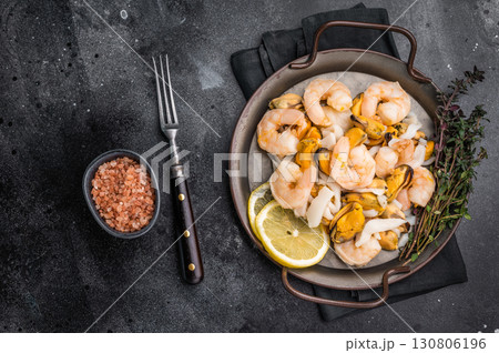 Fresh Seafood Mix with Mussels, Clams, Prawns, Shrimps and squid. black background. top view Fresh Seafood Mix with Mussels, Clams, Prawns, Shrimps and squid. black background. top view 130806196