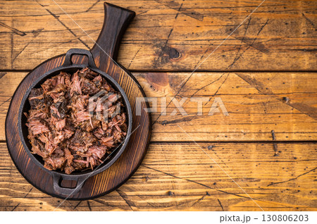 Barbecue wagyu meat torn to bits pulled beef in a skillet. wooden background. top view 130806203