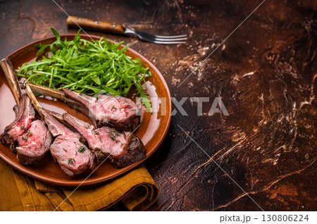 Roasted lamb chop cutlets, mutton meat steaks with salad. brown background. top view 130806224