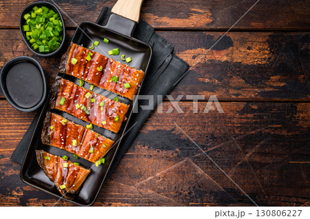 Japanese grilled eel with sweet soy sauce . wooden background. top view Japanese grilled eel with sweet soy sauce . wooden background. top view 130806227