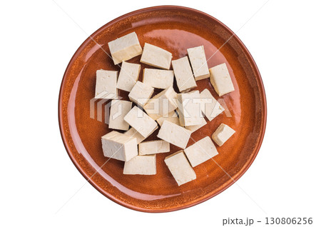 Uncooked Diced soybean tofu cheese on plate isolated on white background. top view 130806256