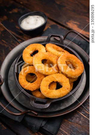 Crispy Fried squid rings, calamari fastfood snack. wooden background. top view Crispy Fried squid rings, calamari fastfood snack. wooden background. top view 130806295