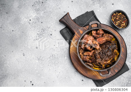 Red Wine Braised Beef Cheek meat with Creamy sauce in a skillet. grey background. top view 130806304