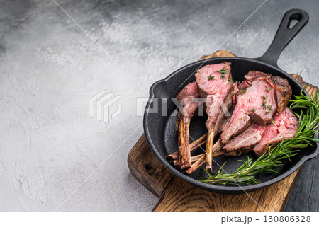 Roast lamb chops, mutton meat cutlets in a skillet. grey background. top view 130806328