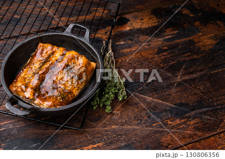 Teriyaki salmon fish fillet with glaze in a skillet. wooden background. top view 130806356