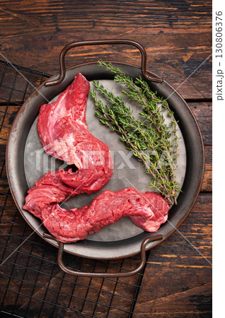 Raw Beef Machete Skirt Steak, fresh marble meat with herbs. wooden background. top view 130806376
