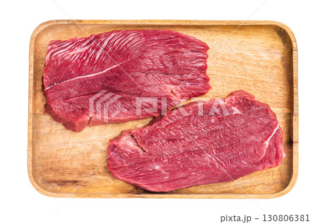 Raw Ostrich steaks, fresh Game Meat in wooden tray isolated on white background. top view 130806381