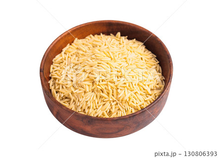 Raw Orzo pasta, uncooked dry Italian risoni in a bowl isolated on white background. top view 130806393