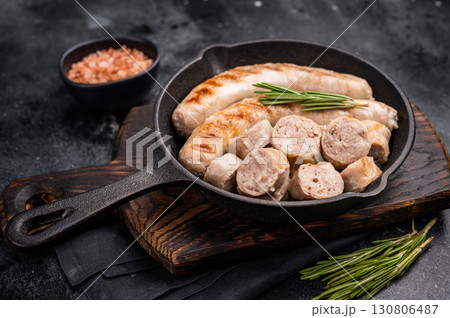 Fried BBQ Sausages with pork and beef meat in pan. black background. top view Fried BBQ Sausages with pork and beef meat in pan. black background. top view 130806487