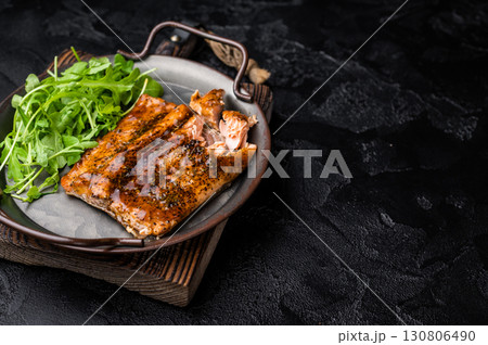 Roasted Teriyaki salmon fillet with salad. black background. top view Roasted Teriyaki salmon fillet with salad. black background. top view 130806490