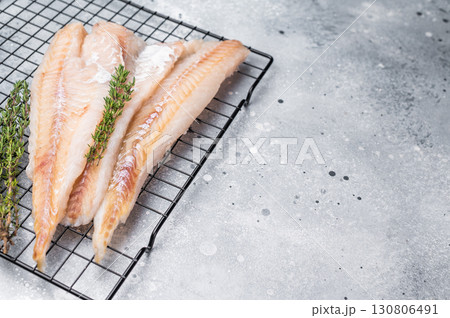 Raw pollock white fish fillet with thyme. grey background. top view 130806491