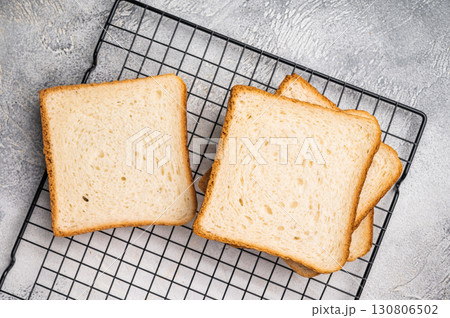 Square Slices of loaf wheat bread for toasts. white background. top view Square Slices of loaf wheat bread for toasts. white background. top view 130806502
