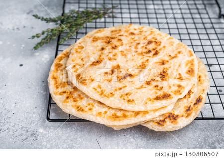 Homemade Kerala wheat paratha, layered parotta. grey background. top view Homemade Kerala wheat paratha, layered parotta. grey background. top view 130806507