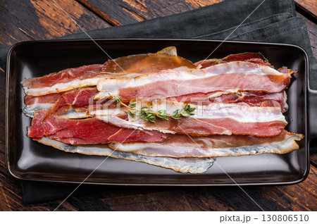 Smoked duck pastrami meat slices. wooden background. top view Smoked duck pastrami meat slices. wooden background. top view 130806510