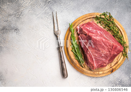 Uncooked Raw Boar meat on wooden board with herbs for cooking. white background. top view Uncooked Raw Boar meat on wooden board with herbs for cooking. white background. top view 130806546