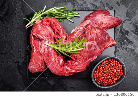 Raw Beef Machete Steak, also name Skirt steak, fresh marble meat. black background. top view Raw Beef Machete Steak, also name Skirt steak, fresh marble meat. black background. top view 130806556