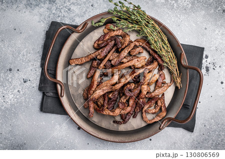 Deep fried beef tender strips, sliced meat in a tray. grey background. top view 130806569
