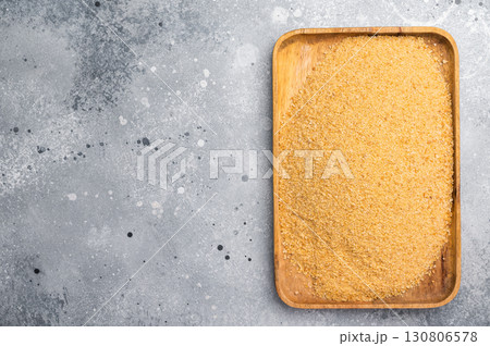 Homemade organic bread crumbs in a wooden tray. gray background. top view Homemade organic bread crumbs in a wooden tray. gray background. top view 130806578