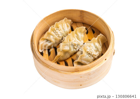 Steamed Japanese Gyoza Dumplings with pork meat and vegetables in bamboo steamer isolated on white background. top view 130806641