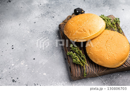 Fresh hamburger buns on wooden board. grey background. top view 130806703