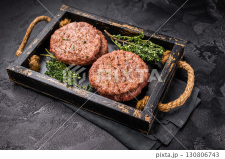 Grilled hamburger mince meat patties with herbs. black background. top view 130806743