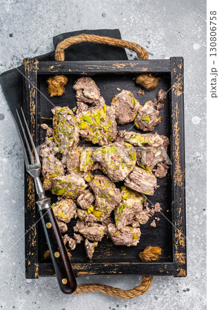 Turkish Halva with pistachio and Sesame in a wooden tray. Natural vegetarian sweets. gray background. top view 130806758