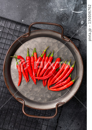 Hot Red chili peppers in a steel tray isolated on white background. top view 130806762