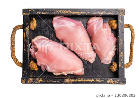 Raw Chicken thighs fillets in a wooden tray isolated on white background Raw Chicken thighs fillets in a wooden tray isolated on white background 130806802