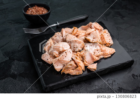 Shredded salmon, roasted fillets on a marble board. black background. Top view Shredded salmon, roasted fillets on a marble board. black background. Top view 130806823