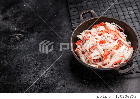japanese Crab meat, crabmeat imitation in a skillet. black background. top view 130806855