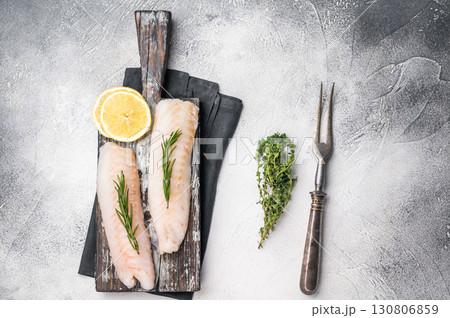 Raw cod Loin, white fish fillets without skin on wooden board. white background. top view 130806859