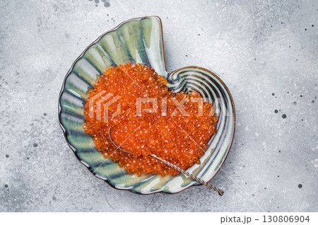Beautifully presented red roe, a delicacy that enhances every meal with its unique taste and texture. grey background. top view Beautifully presented red roe, a delicacy that enhances every meal with its unique taste and texture. grey background. top view 130806904