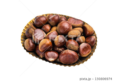 Heap of fresh chestnuts in kitchen tray ready for roasting isolated on white background Heap of fresh chestnuts in kitchen tray ready for roasting isolated on white background 130806974