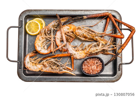 Deliciously grilled giant river prawns on steel tray, ideal for summer gatherings and outdoor feasts. isolated on white background. top view Deliciously grilled giant river prawns on steel tray, ideal for summer gatherings and outdoor feasts. isolated on white background. top view 130807056