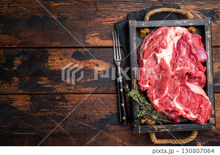 Tender raw beef neck meat, a versatile ingredient for delicious soups and comforting family dinners. wooden background. top view Tender raw beef neck meat, a versatile ingredient for delicious soups and comforting family dinners. wooden background. top view 130807064