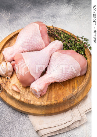 Raw poultry drumsticks, chicken legs ready for cooking with herbs and spices. white background. top view 130807076