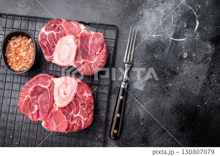 Fresh raw ossobuco Premium veal shank, ideal for slow cooking and creating hearty, comforting meals that impress. black background. top view Fresh raw ossobuco Premium veal shank, ideal for slow cooking and creating hearty, comforting meals that impress. black background. top view 130807079