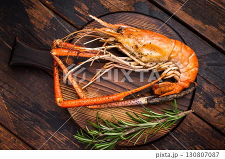 Juicy grilled giant river prawn shrimp served with rosemary, a mouthwatering dish for your next barbecue. wooden background. top view 130807087