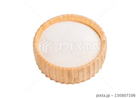 Versatile white sugar in a rustic bowl, ready to enhance desserts and beverages with its delightful sweetness. isolated on white background. top view 130807106