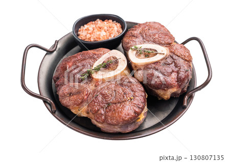 Deliciously braised ossobuco, featuring tender osso buco veal shank and rich marrow, perfect for a gourmet Italian feast. isolated on white background. top view Deliciously braised ossobuco, featuring tender osso buco veal shank and rich marrow, perfect for a gourmet Italian feast. isolated on white background. top view 130807135