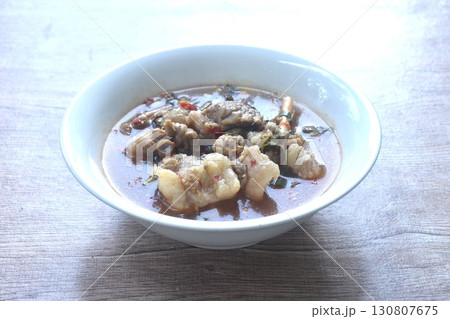 boiled slice braised beef meat with chili in clear tom yum soup on bowl  130807675