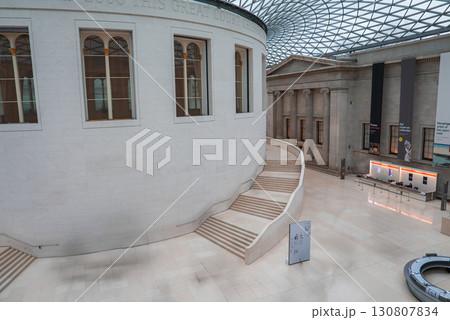 The British Museum's Great Court features the circular Reading Room, a geometric glass roof, sweeping staircase, and classical architectural details. 130807834