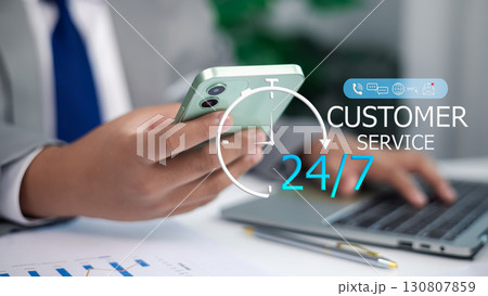 Businessman using smartphone with 24/7 customer service support and digital communication icons 130807859