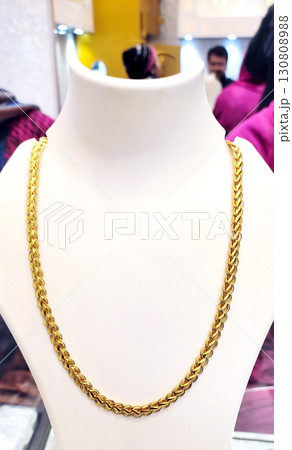Elegant Gold Chain Displayed on Jewelry Mannequin 130808988